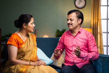 couple agreeing up on by talking or discuissing each other at home - concept of long relationship, communication and conversation.