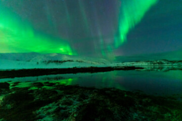 Fototapeta na wymiar aurora borealis northern lights in karvik town of tromso, norway