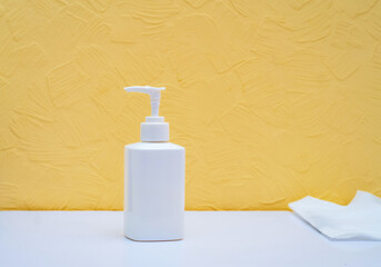 White can of dispenser for dysenfection of hands on the table