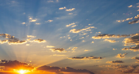 Fototapeta premium Rising Sun Shoots Out Light Rays Into The Clouds 