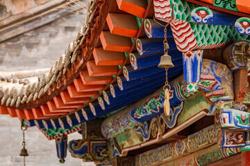 Colorful roof construction with wind chimes on a temple in Kumbum Jampaling Monastery, Xining, China