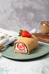 Rolled log cake. Strawberry and cream cake on a stone background. Patisserie desserts