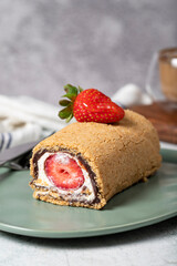 Rolled log cake. Strawberry and cream cake on a stone background. Patisserie desserts