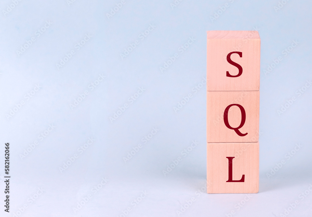 Poster sql - structured query language on wooden cubes on a blue background