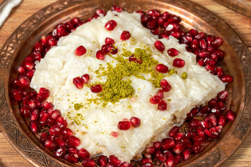 Gullac dessert. Milky dessert made special for the month of Ramadan. Traditional Turkish cuisine delicacies. gullac dessert on a copper plate. Close up