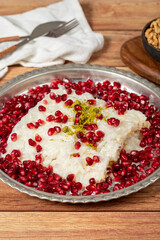Gullac dessert. Milky dessert made special for the month of Ramadan. Traditional Turkish cuisine delicacies. gullac dessert on a copper plate. Close up