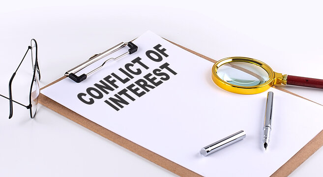 CONFLICT OF INTEREST text on clipboard on white background, business concept