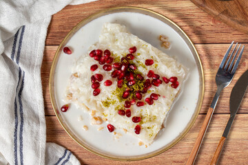 Gullac dessert. Milky dessert made special for the month of Ramadan. Traditional Turkish cuisine delicacies. gullac dessert on plate. Top view