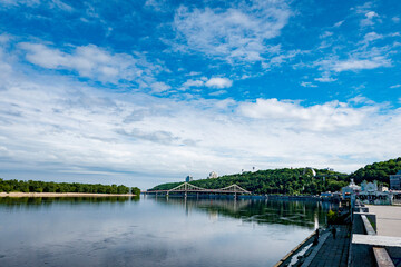 river Dnipro bridge in the city with blue sky and clouds in Kyiv