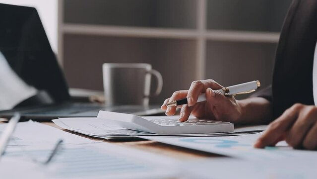Financial analysts analyze business financial reports on a digital tablet planning investment project during a discussion at a meeting of corporate showing the results of their successful teamwork.