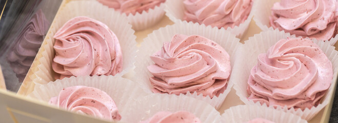 handmade fruit marshmallows in paper packaging on the table. home bakery concept.