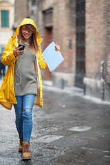 Girl in city walking and listening music