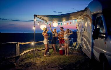 Friends having party while camping together; Casual lifestyle concept