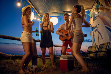 Group of friends having fun camping together; Casual lifestyle concept