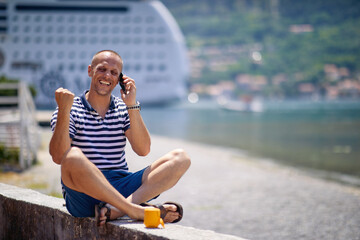 Happy male traveler exploring the seaside alone