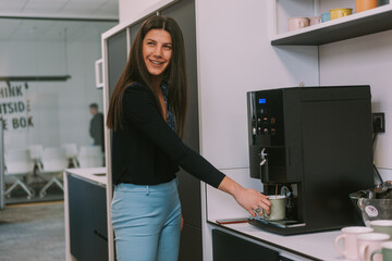 Fototapeta na wymiar Business woman making coffee