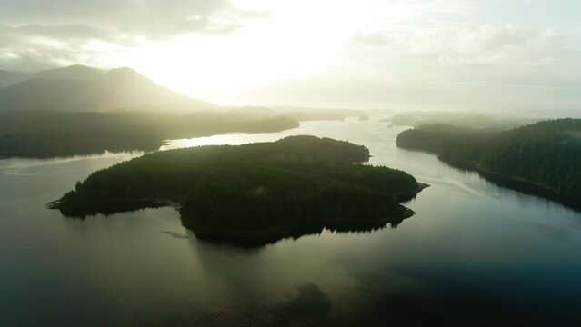 Aerial Ucluelet Vancouver Island British Columbia Misty island mountains West Coast Canada Pacific Ocean coast. Beautiful Pacific Rim National Park Golden sunrise blue water green forest