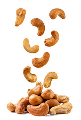 Roasted cashew nuts fall on a pile on a white background. Isolated