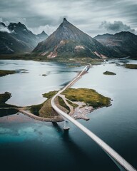 Vertical shot of Fredvang Bridges surrounded by rocky hills in Norway