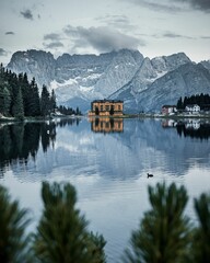 Vertical shot of Lake Misurina surrounded by rocky mountains in Italy