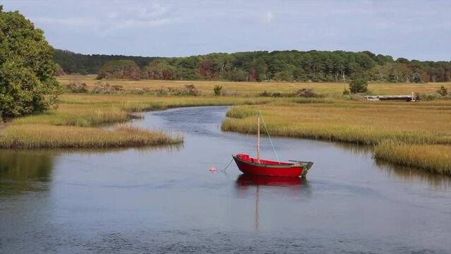 Old Fashioned Red Rowboat at Herring River at Harwich, Cape Cod