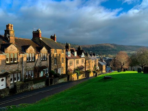 A row of traditional stone houses in partial sunshine on a winters day in Bakewell, Derbyshire, UK.
