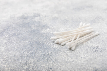 Cotton buds on a concrete table background. Hygienic cotton sticks on a textured background.ear sticks. Place for text. Place to copy.Closeup.