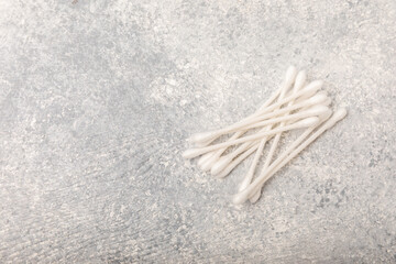 Cotton buds on a concrete table background. Hygienic cotton sticks on a textured background.ear sticks. Place for text. Place to copy.Closeup.