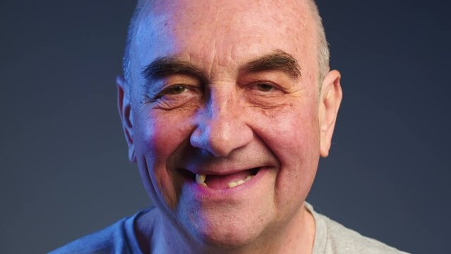 Periodontal disease and missing teeth in an elderly man. Close up shot of a toothless male mouth. Man showing his rotten teeth, caries, decayed and weak enamel, teeth falling out, dental problems