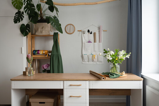 Table with bouquet of flowers in workshop