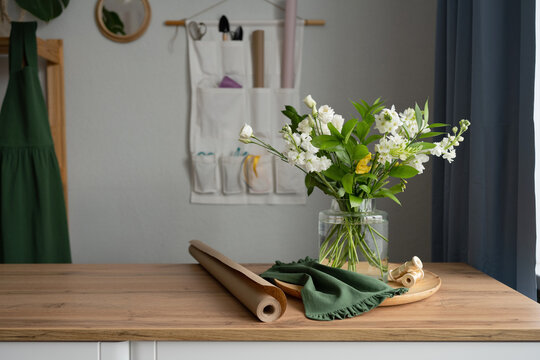 Glass vase with bouquet of white flowers