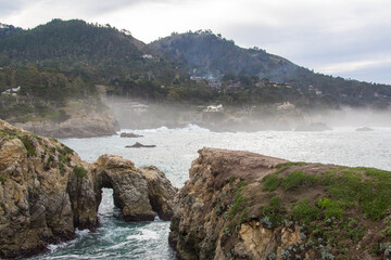 The rocky California coastline as off the Pacific Coast Highway near the Big Sur area. Classic foggy conditions and rough waters.
