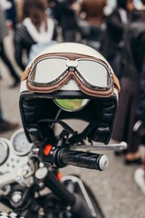 Vertical closeup shot of a black safety helmet on a motorbike