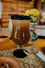 Glass of a Tamarind drink on a wooden table