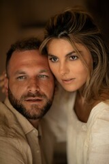 a man and woman sitting next to each other in front of a camera