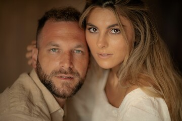 a man and woman posing together while wearing white shirt and brown hair