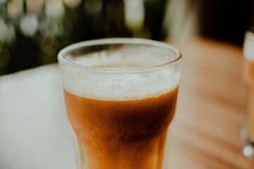 Glass of a Tamarind drink on a wooden table