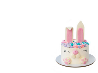 White and pink cake with cute bunny for children's birthday or Easter. Bunny made of fondant and...