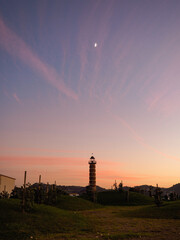 Naklejka na ściany i meble Lighthouse and the moon at sunset in Belém, Lisbon, Portugal
