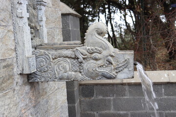 Antique style water tap madeup of natural stone with beautiful architectural design located in the outside of the temple