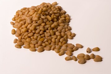 fresh peeled pine nuts on a white background