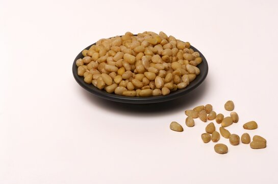 fresh peeled pine nuts on a white background