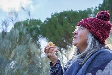 woman eating an apple in the mountains