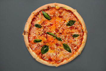 pizza margherita cut out on gray background top view