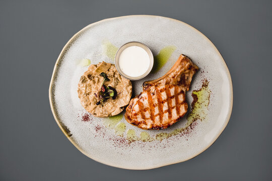 Tibon with a side dish on a designer plate, close up