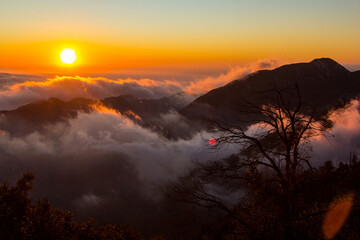 Watching the sunset over the clouds, looking over the city of Los Angeles. Views from Angeles National Forest