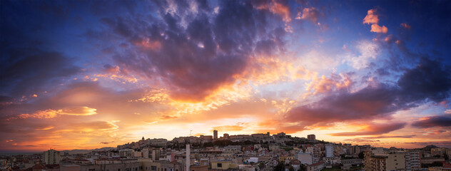 Cagliari skyline with colorful sunset. Panoramic sunset view on Cagliari skyline.