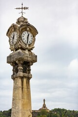 Fototapeta na wymiar Vertical shot of the clock tower against a clouded sky