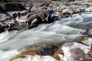 lozoya river in madrid flowing between the granite rocks