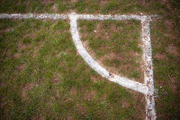 Football pitch markings at corner on muddy pitch